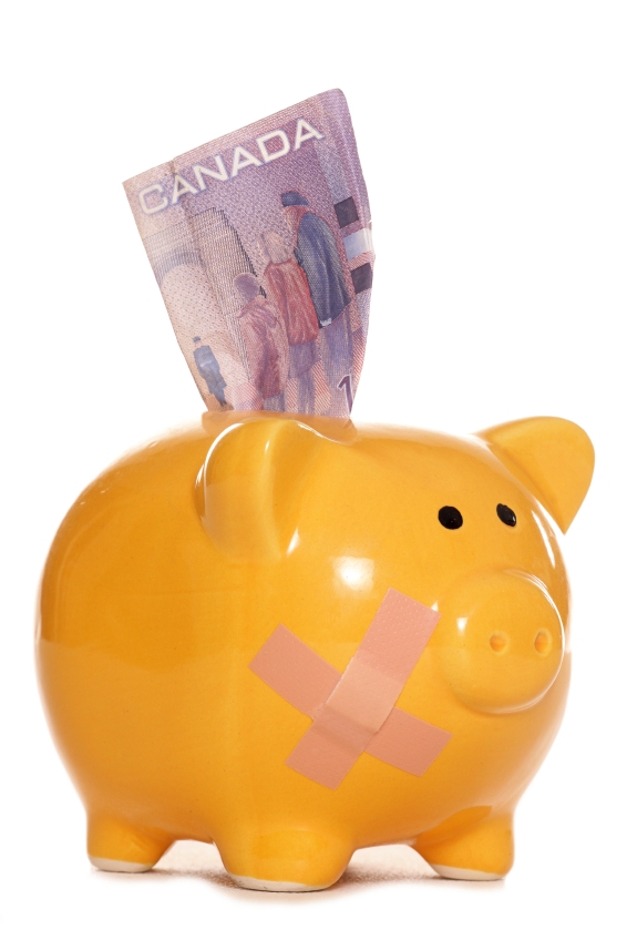 Canadian dollars in a piggy bank studio cutout